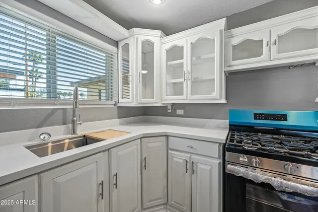 a kitchen with stainless steel appliances granite countertop a sink and a stove