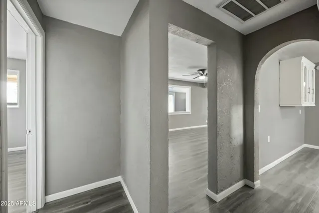 a view of empty room with wooden floor