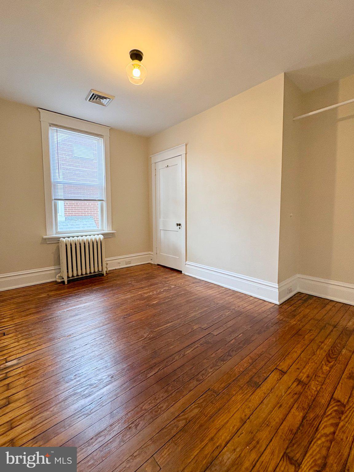 616 North Front Street Wormleysburg, PA 17043 - Photo 21 of 25 an empty room with wooden floor and windows
