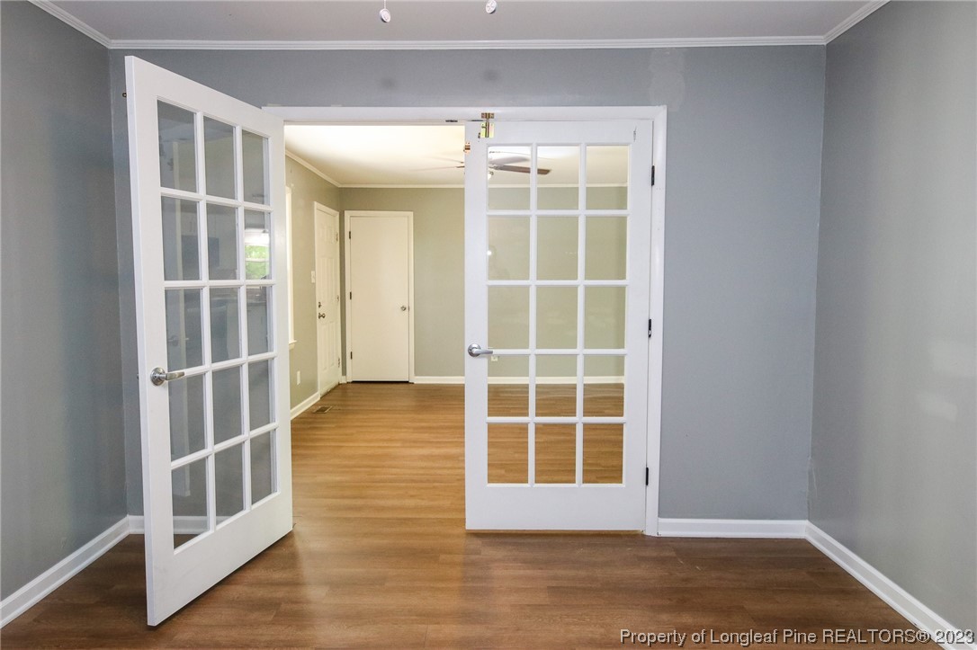 782 Horne Road Rowland, NC 28383 - Photo 4 of 27 an empty room with wooden floor and windows