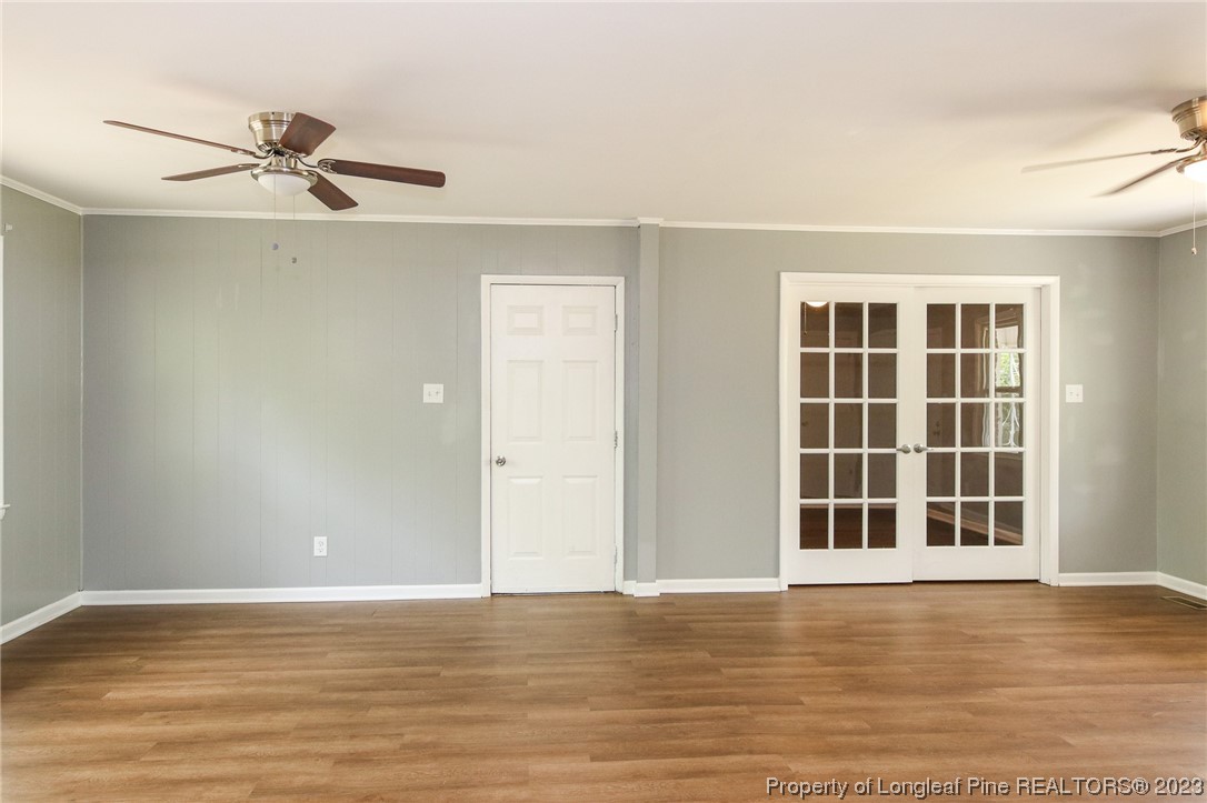 782 Horne Road Rowland, NC 28383 - Photo 5 of 27 a view of an empty room with a window and wooden floor