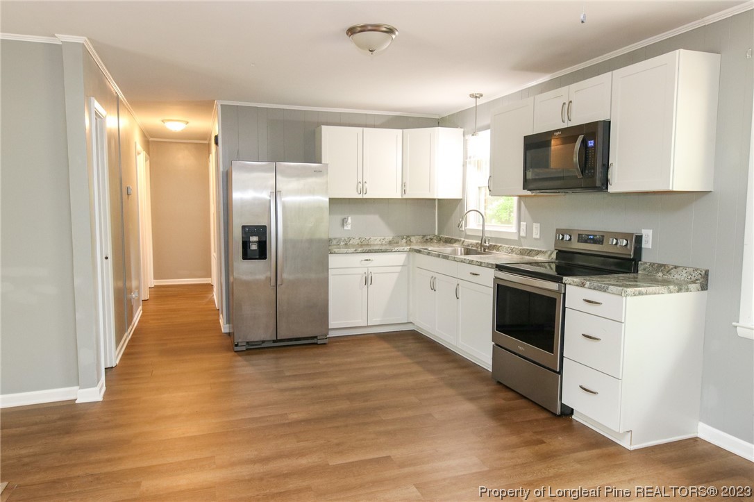 782 Horne Road Rowland, NC 28383 - Photo 7 of 27 a kitchen with stainless steel appliances granite countertop a refrigerator a stove a sink and a microwave