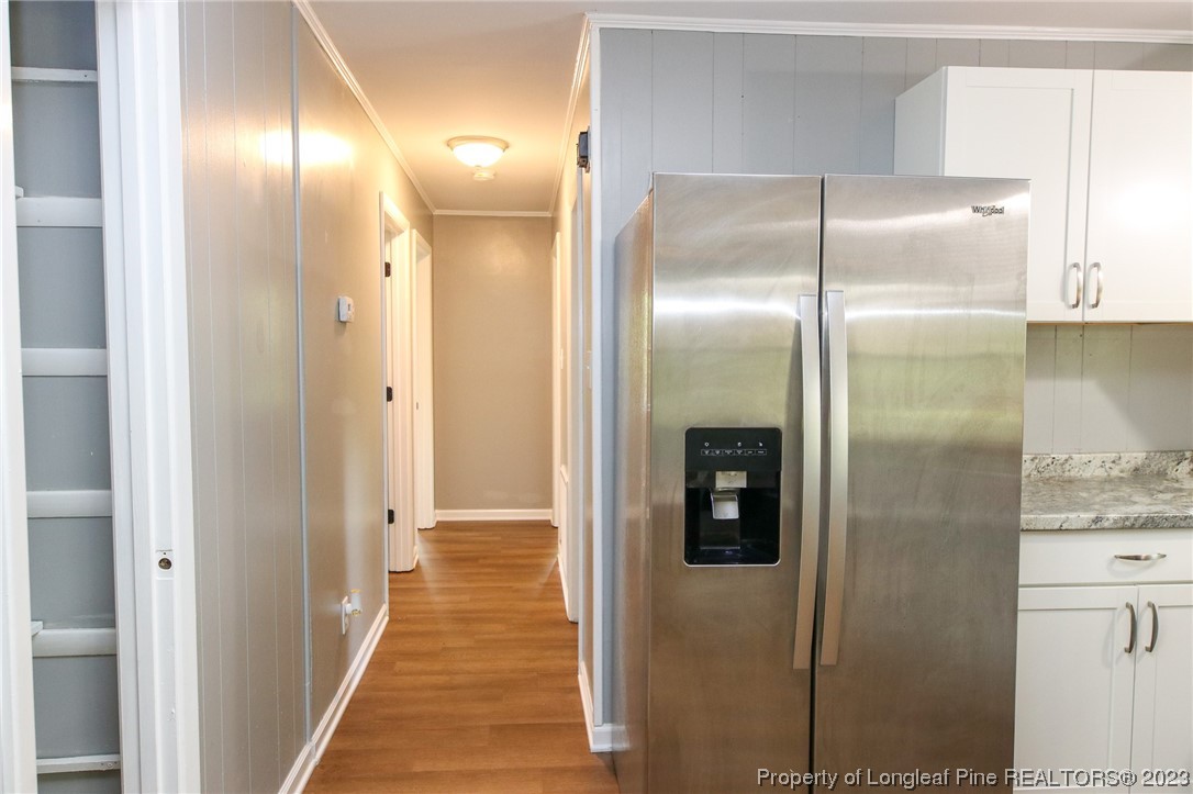 782 Horne Road Rowland, NC 28383 - Photo 8 of 27 a view of a hallway with wooden cabinets