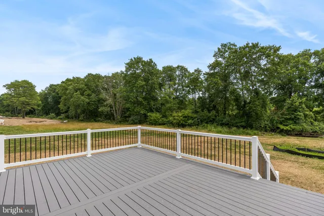 a view of a roof deck with wooden floor and fence