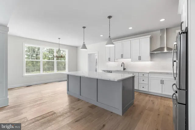 a kitchen with sink cabinets and wooden floor