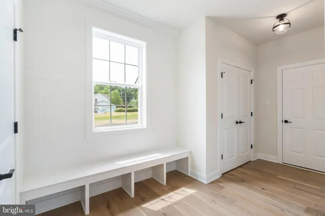 a open kitchen with stainless steel appliances granite countertop a refrigerator a oven and a wooden floors