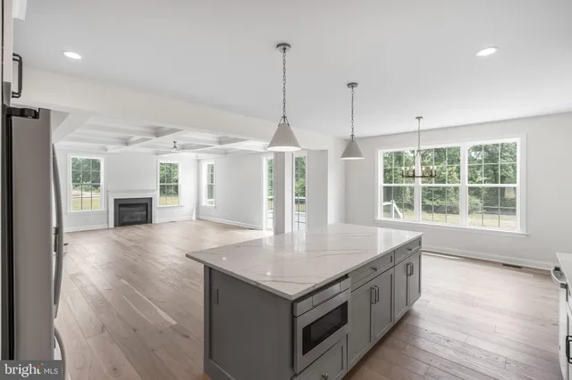a kitchen with granite countertop a sink and a refrigerator