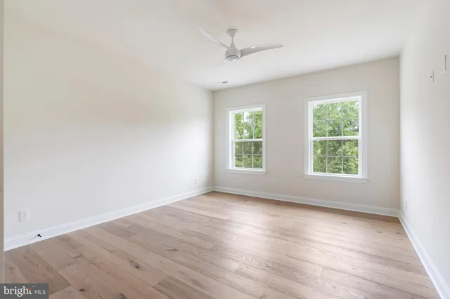 a bathroom with a double vanity sink a toilet and a mirror