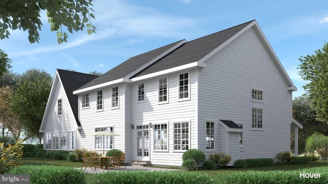 a front view of a house with a yard and green space