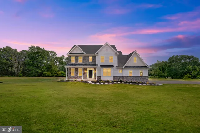 a front view of a house with a big yard