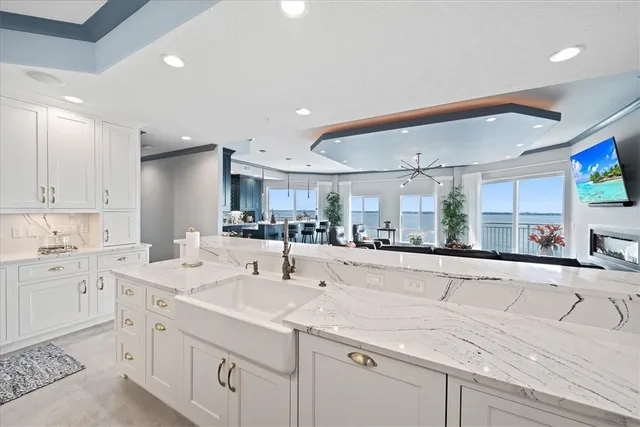 a kitchen with sink and view living room