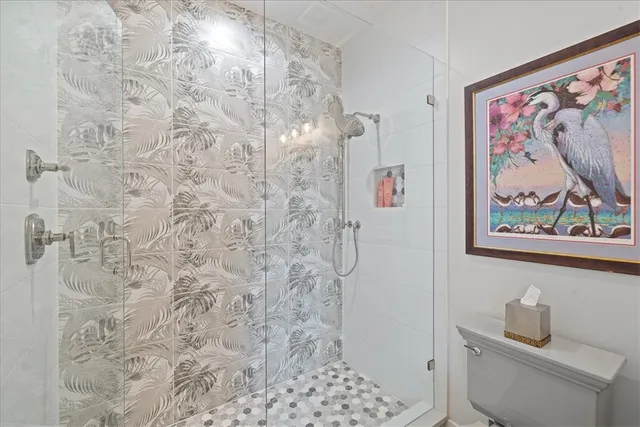 a bathroom with a toilet and a shower curtain