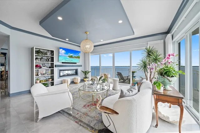 a living room with fireplace furniture and a potted plant