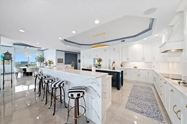 a kitchen with a table chairs microwave and cabinets