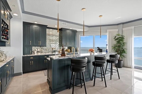 a kitchen with a table chairs sink and stove