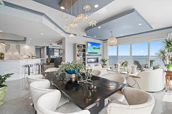 a living room with kitchen island furniture and a chandelier