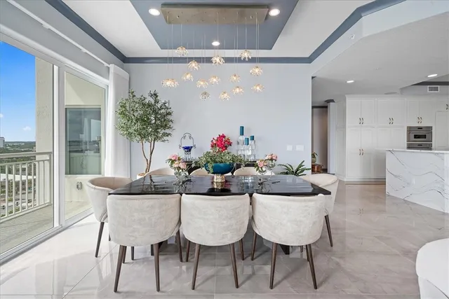a dining room with furniture potted plants and wooden floor