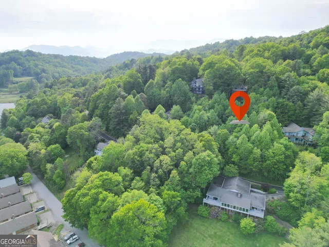an aerial view of a house with a backyard space