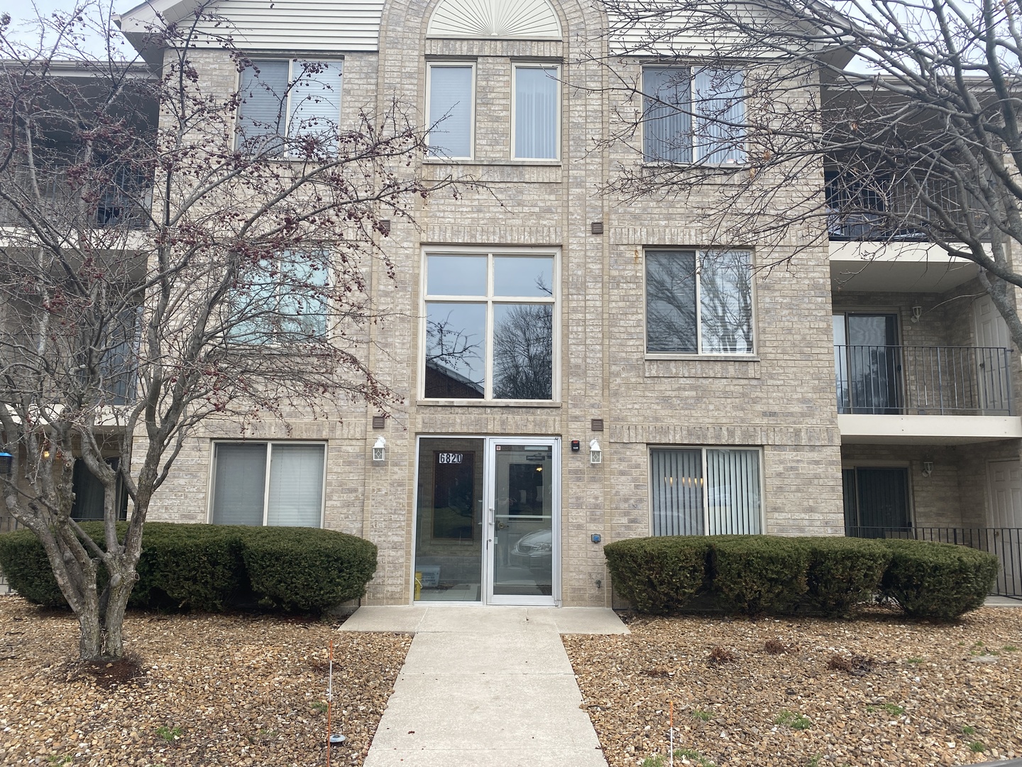 a view of a brick house with a yard