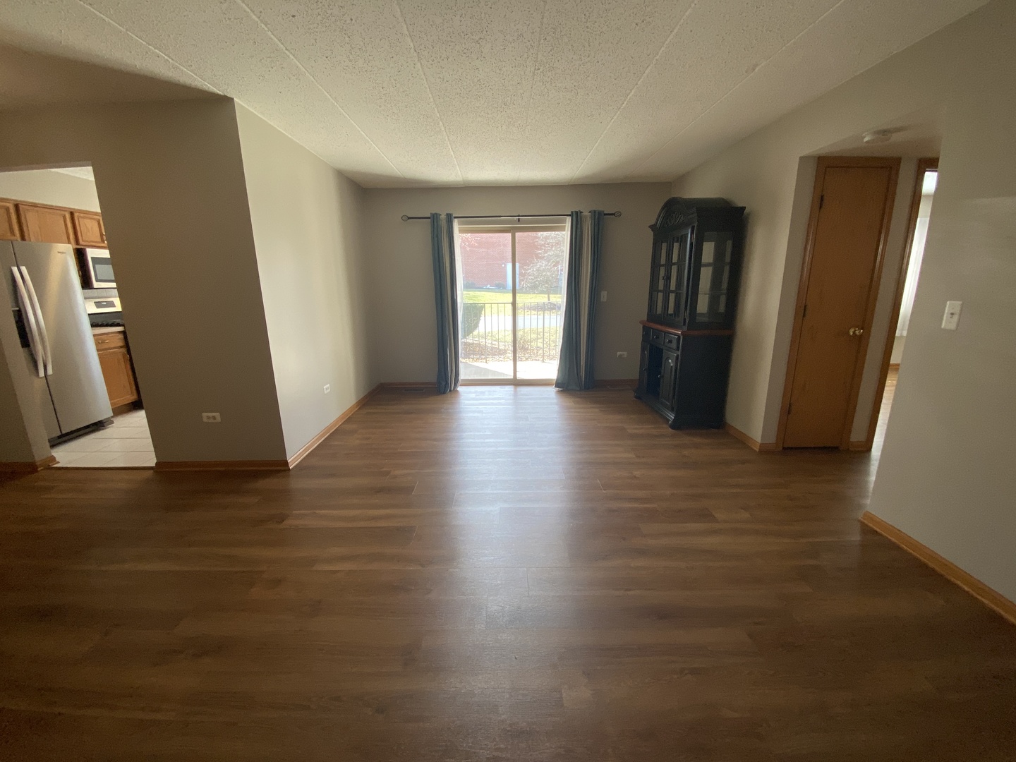 6820 Ridge Point Drive, Unit 21A Oak Forest, IL 60452 - Photo 7 of 16 a view of an empty room with wooden floor and a window