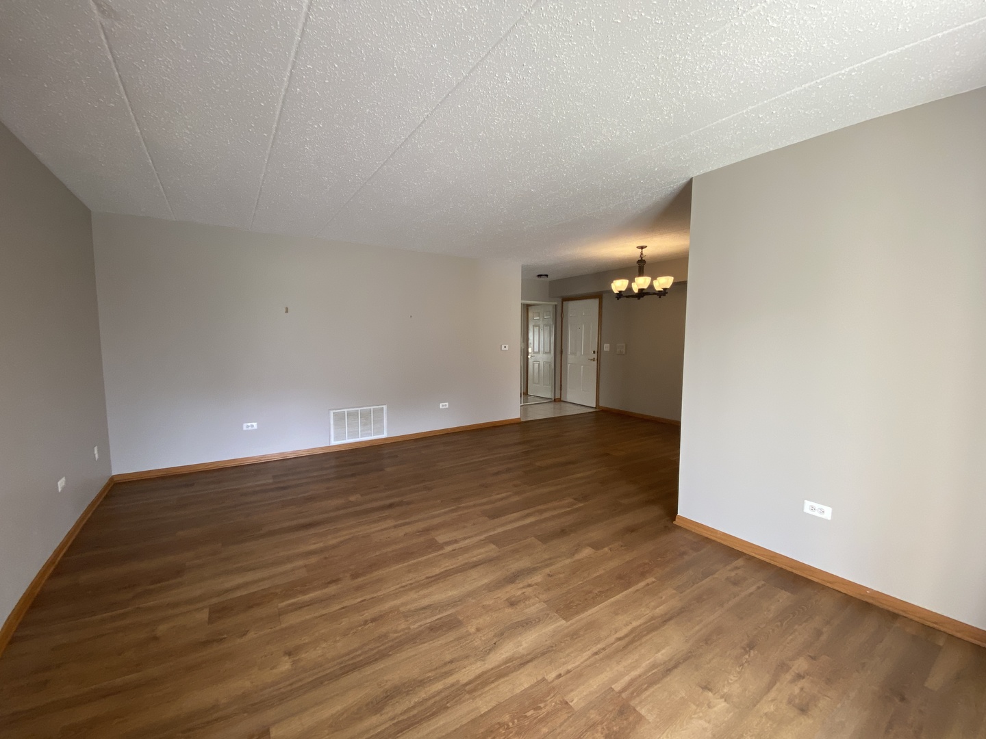 6820 Ridge Point Drive, Unit 21A Oak Forest, IL 60452 - Photo 9 of 16 a view of an empty room with wooden floor