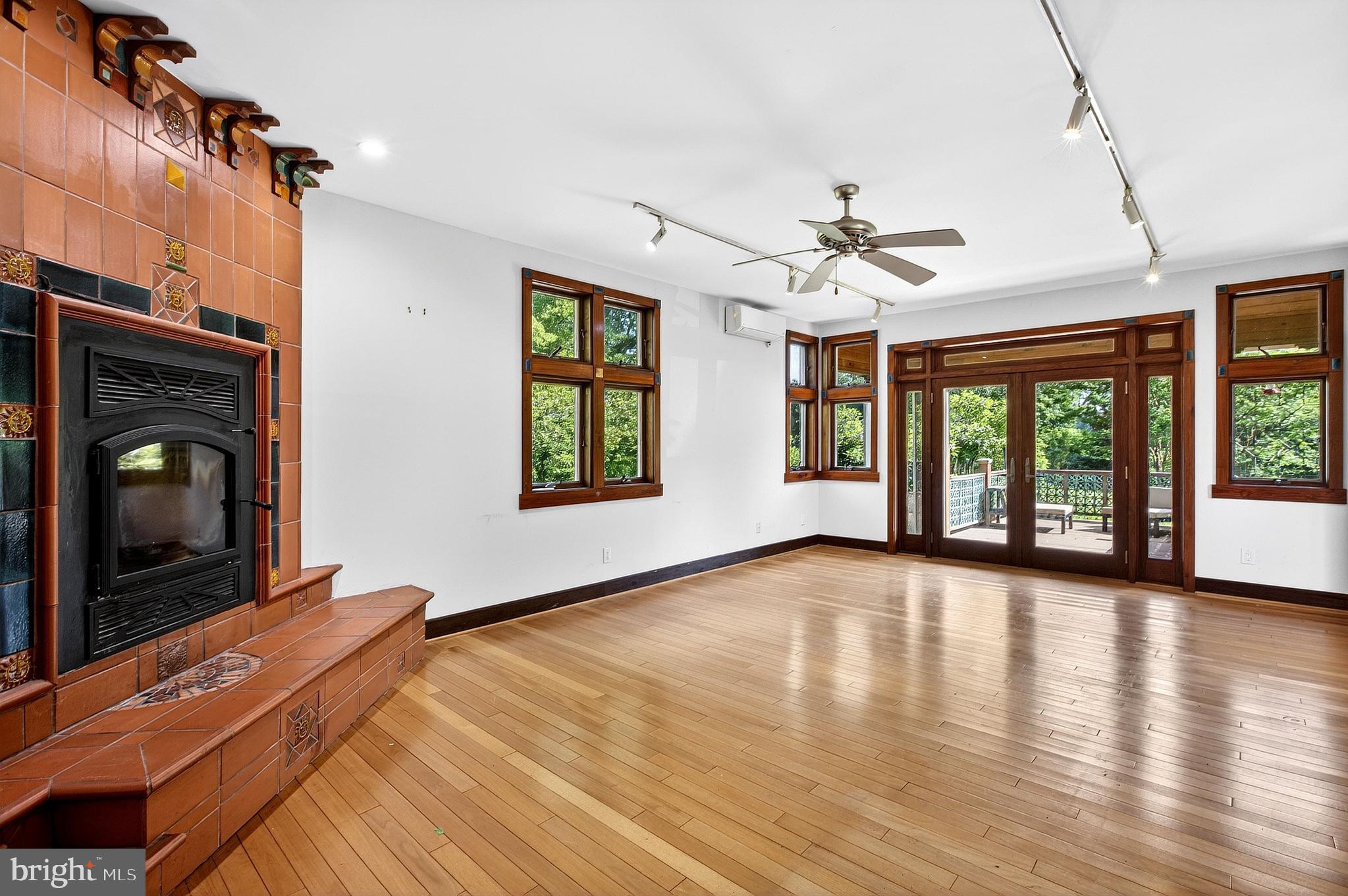 498 Perrineville Road Robbinsville, NJ 08691 - Photo 6 of 59 a view of an empty room with wooden floor fireplace and a window