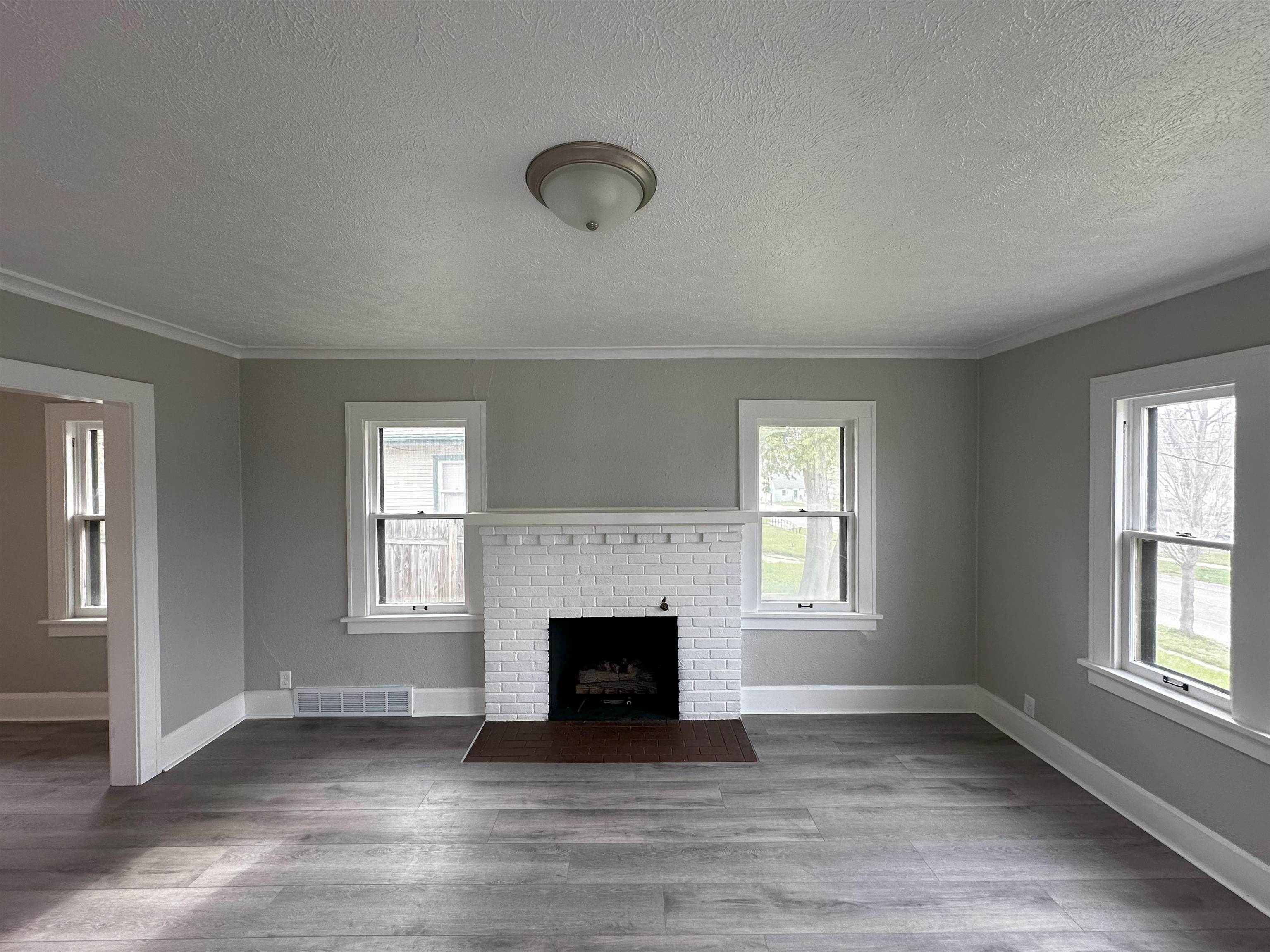 2316 Rural Street Rockford, IL 61107 - Photo 2 of 10 an empty room with windows and fireplace