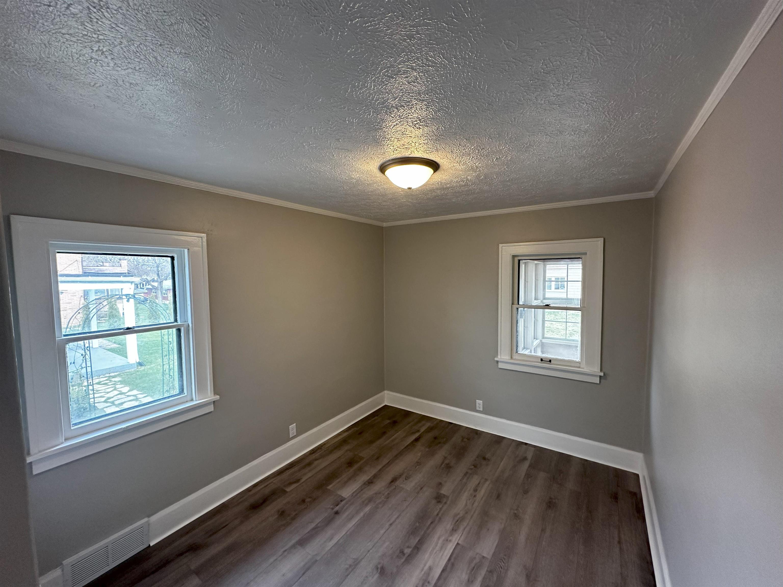 2316 Rural Street Rockford, IL 61107 - Photo 6 of 10 a view of an empty room with wooden floor and a window