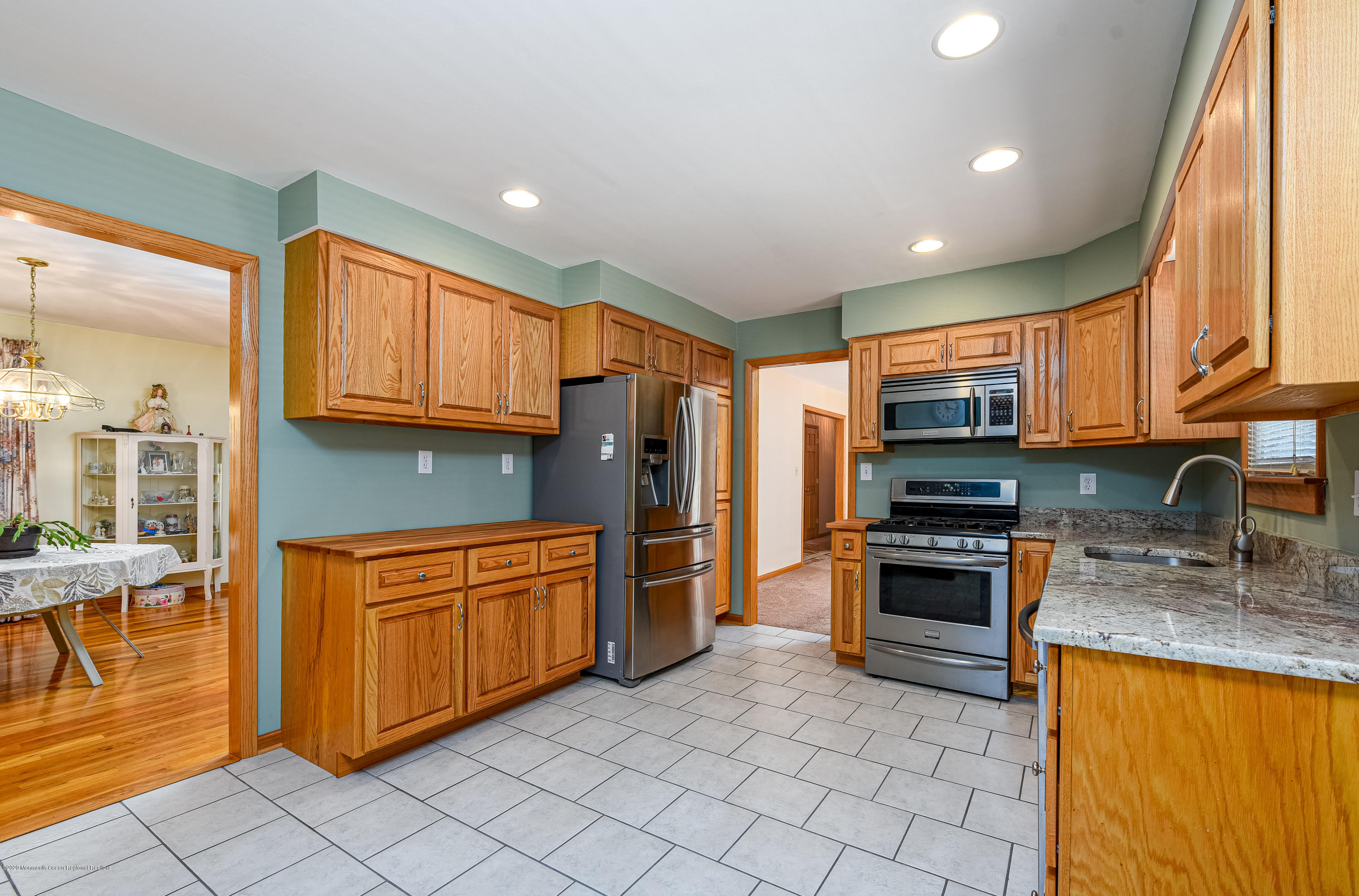 32 South Westfield Road Howell, NJ 07731 - Photo 7 of 28 a kitchen with stainless steel appliances granite countertop a stove top oven a sink dishwasher and cabinets with wooden floor