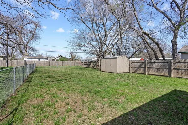 a view of a backyard with large tree