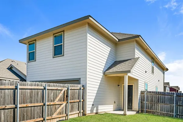 a view of a house with wooden fence