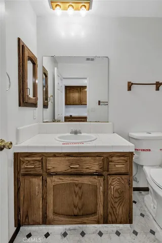 a view of a big room with wooden floor and a bathroom