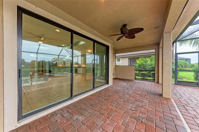 a view of a room with a floor to ceiling window and wooden floor