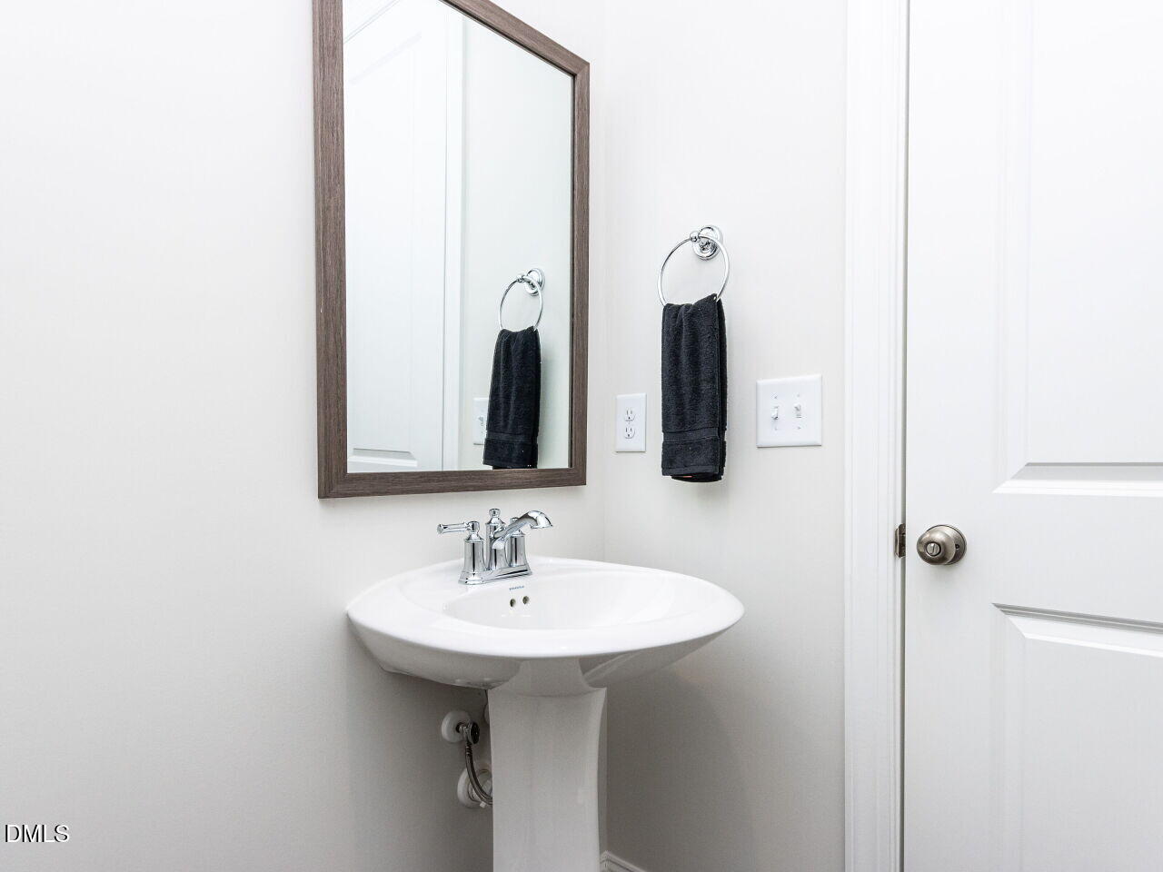 6026 Scalybark Road Durham, NC 27712 - Photo 31 of 55 a bathroom with a sink and a mirror