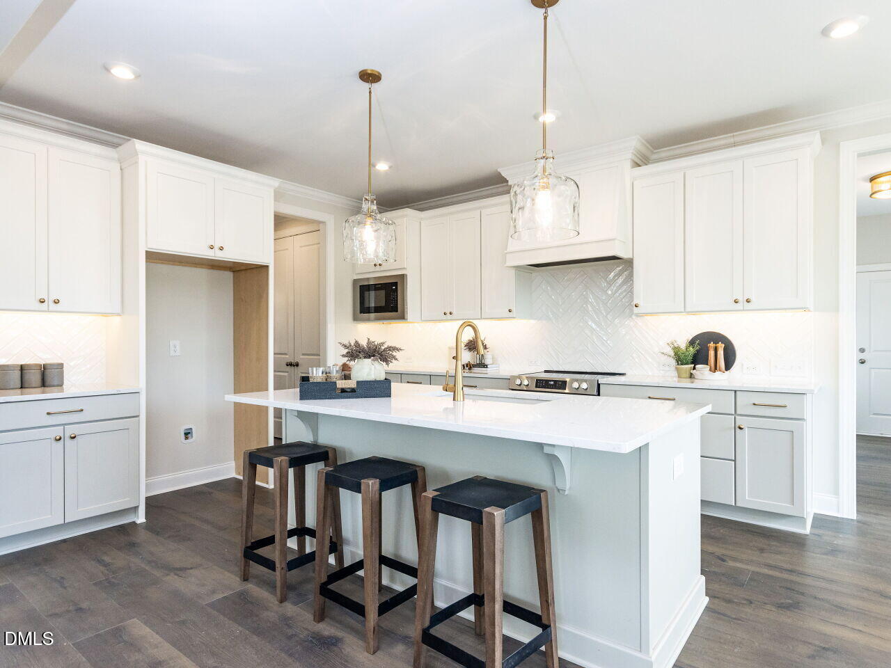 6026 Scalybark Road Durham, NC 27712 - Photo 35 of 55 a kitchen with stainless steel appliances a stove a sink a center island and cabinets