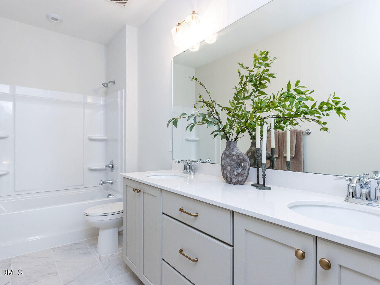 6026 Scalybark Road Durham, NC 27712 - Photo 48 of 55 a bathroom with a sink a toilet and a large mirror