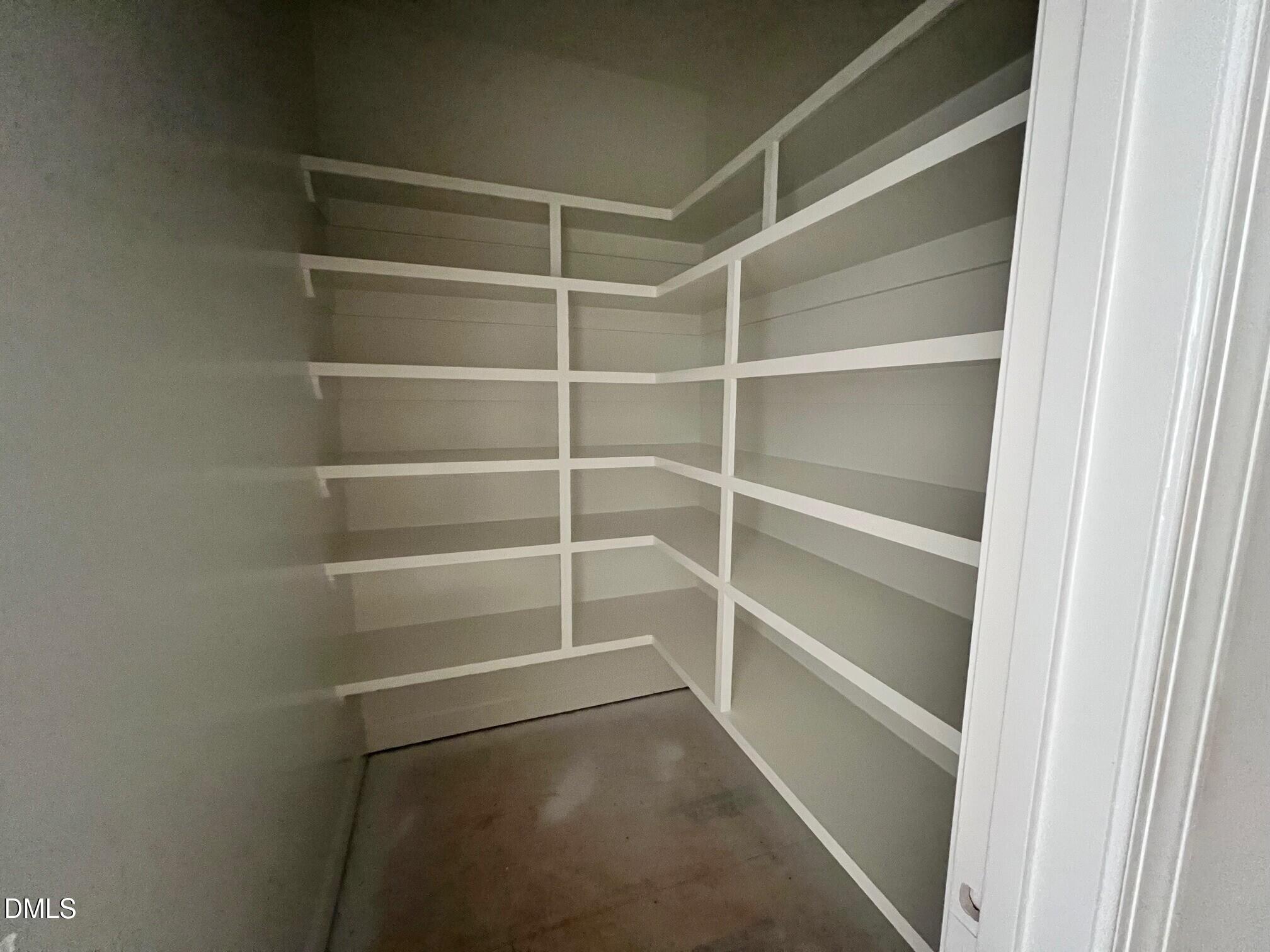 6026 Scalybark Road Durham, NC 27712 - Photo 7 of 55 a view of walk in closet with empty racks