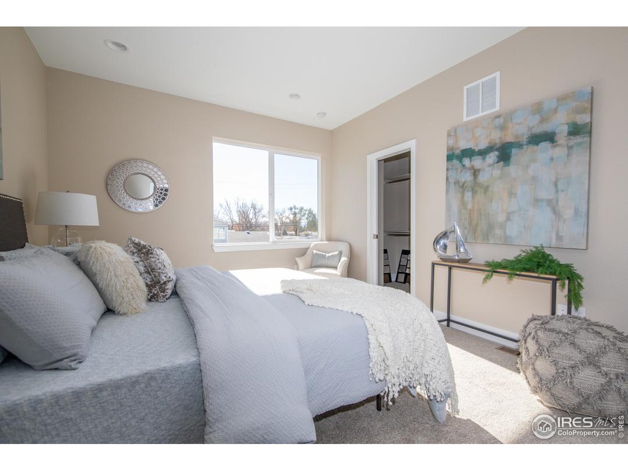1530 South Terry Street Longmont, CO 80501 - Photo 11 of 21 a bedroom with a bed and a large mirror