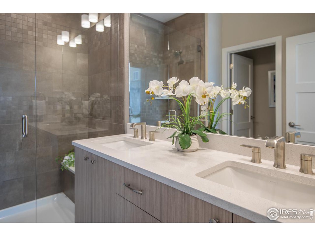 1530 South Terry Street Longmont, CO 80501 - Photo 13 of 21 a bathroom with a sink a vanity and a mirror