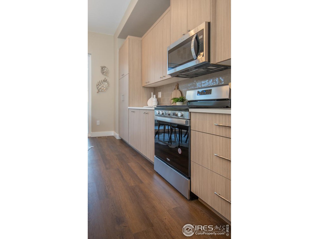 1530 South Terry Street Longmont, CO 80501 - Photo 8 of 21 a kitchen with stainless steel appliances granite countertop a stove and a microwave