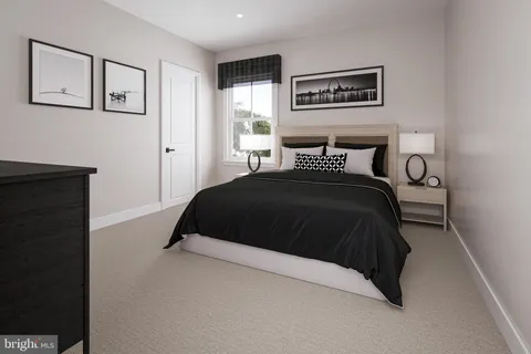 a bedroom with a bed and painting on the wall