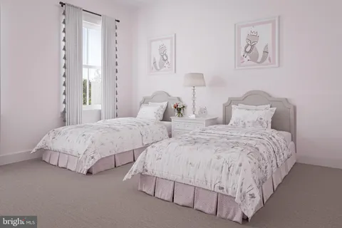 a bedroom with two beds and painting on the wall