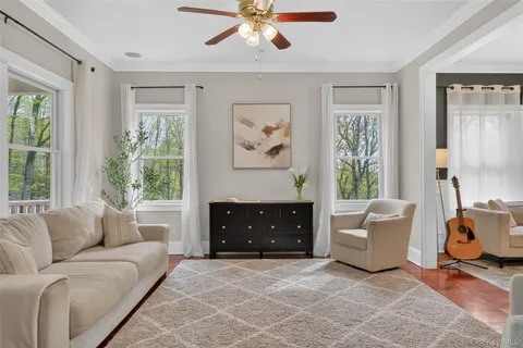 a living room with furniture and a chandelier