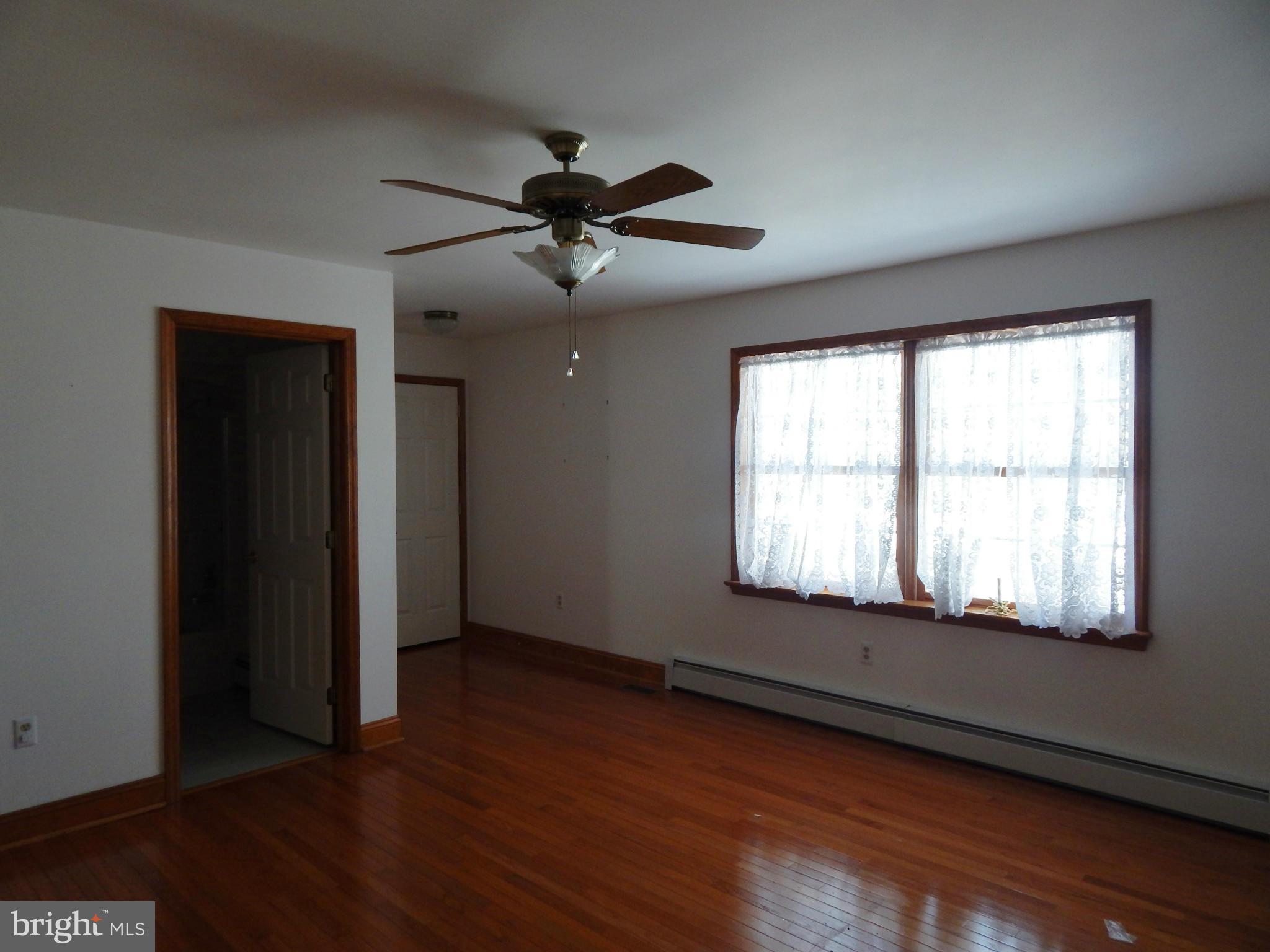 3964 Street Road Street, MD 21154 - Photo 22 of 29 a view of an empty room with wooden floor and a window