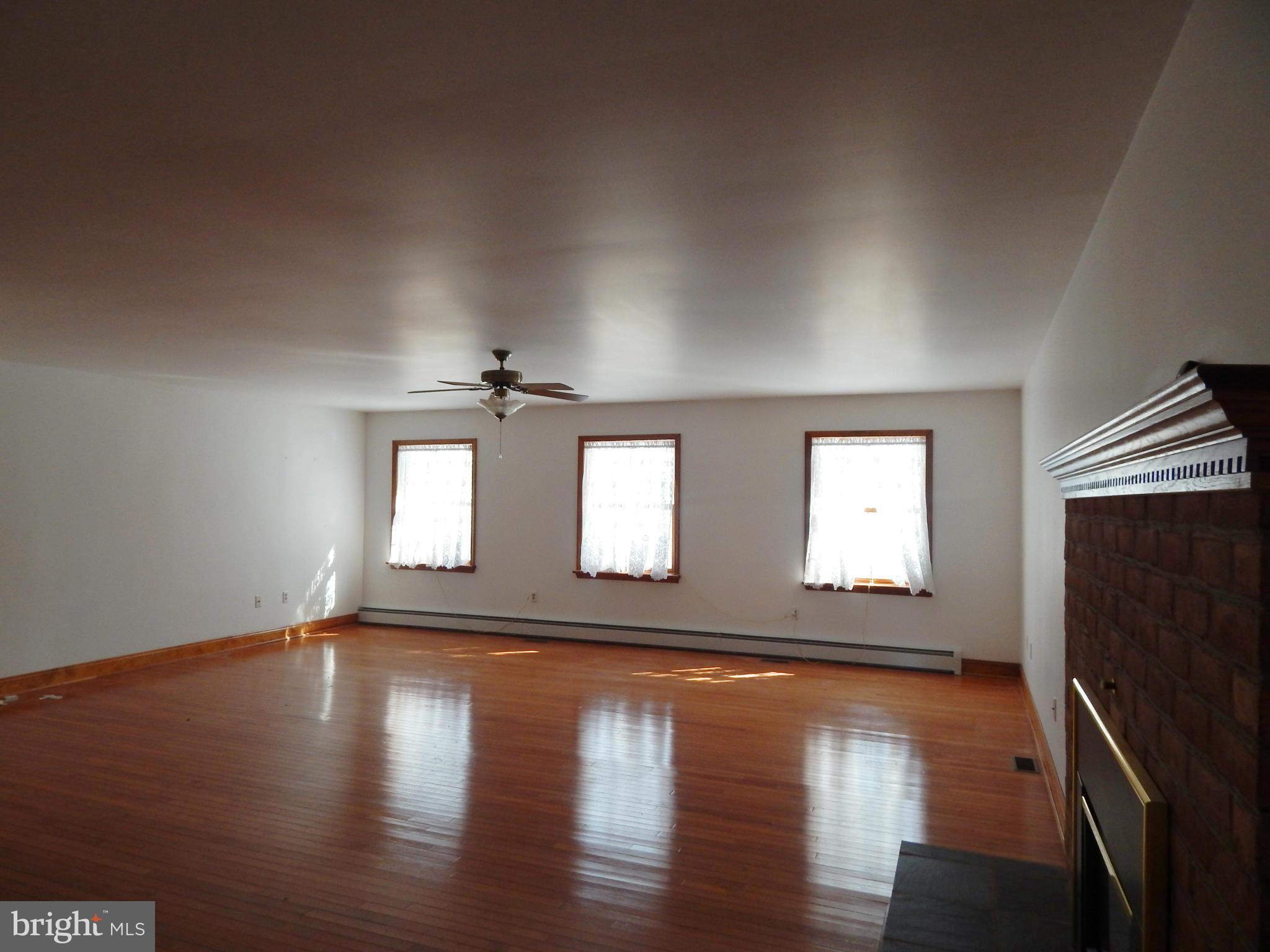 3964 Street Road Street, MD 21154 - Photo 25 of 29 a view of an empty room with wooden floor and a window