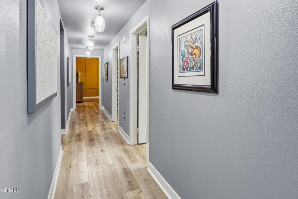 2820 Wagon Wheel Road, Unit 403 Oxnard, CA 93036 - Photo 17 of 35 a view of a hallway with wooden floor and staircase