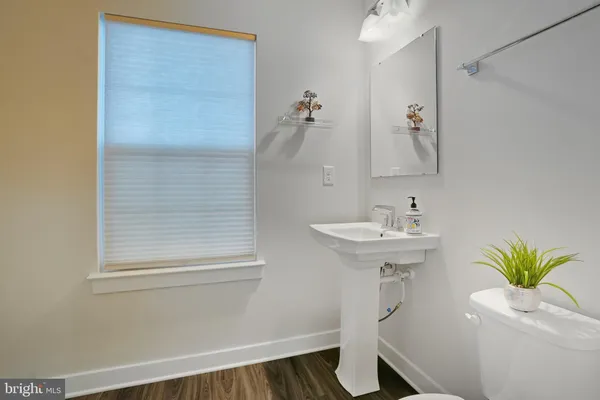 a bathroom with a sink a mirror and a toilet