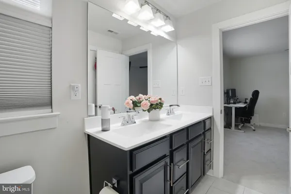 a bathroom with a sink vanity and a mirror