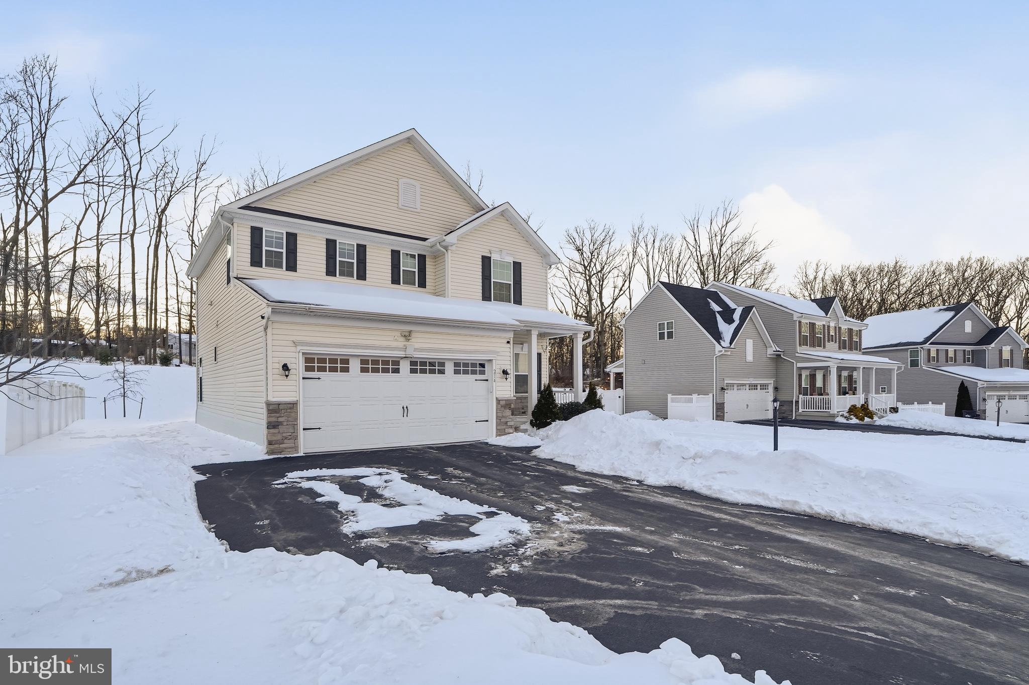 214 Pixie Moss Road Pottstown, PA 19464 - Photo 2 of 27 a view of a white house with a yard covered in snow