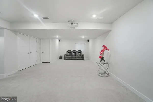 a view of a room with gym equipment and a chandelier